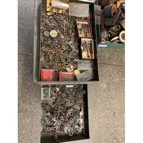 97 - A grey metal filing chest containing clock dials, Georgian and later hands, pocket watch glasses, to... 