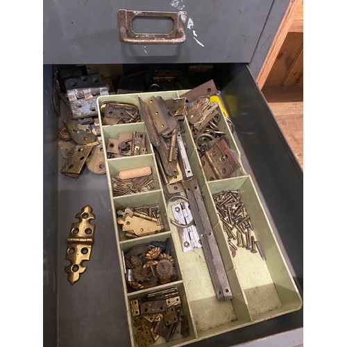 100 - A grey metal filing chest containing carriage clock balances, clock wheels, springs, orb finials, wa... 