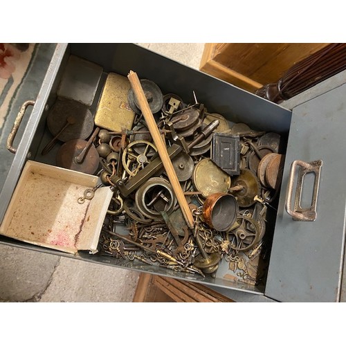 100 - A grey metal filing chest containing carriage clock balances, clock wheels, springs, orb finials, wa... 