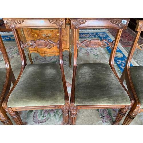 52 - A set of six Regency rosewood framed dining chairs with carved scroll decoration to the cresting rai... 