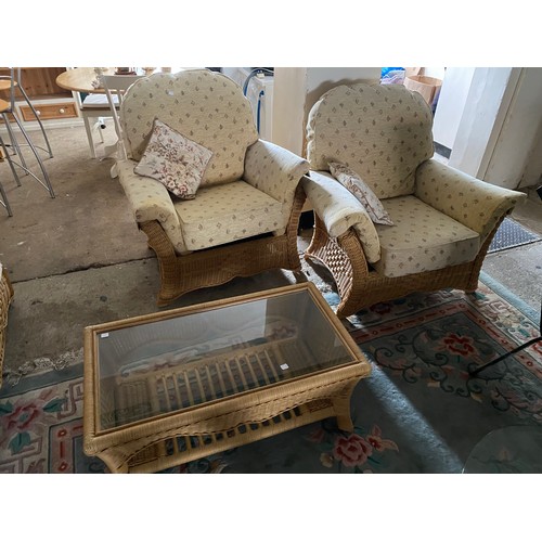 38 - A cane three piece conservatory suite and matching coffee table with inset glass top