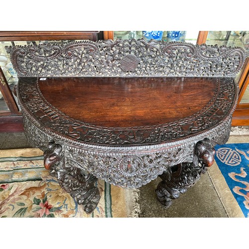 74 - An Indian padouk wood sidetable with half round top, carved and pierced to birds, flowers and leaves... 