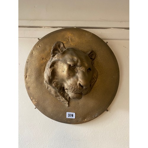 378 - A circular bronzed plaque with raised decoration of tigers head - 14in. dia.