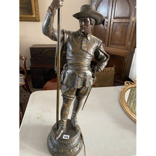 368 - A spelter lamp in the form of a cavalier holding a flaming torch - 39in. high