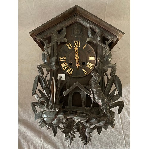 377 - A Black Forest cuckoo clock with leaf and dog decoration to the front