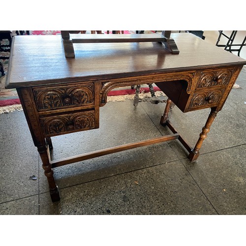 110 - An oak dressing table fitted four drawers with carved decoration, on turned legs, an oak framed swin... 