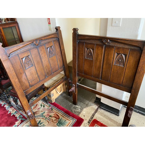 119 - An oak dressing table with carved anthemion leaf decoration, fitted drawers, on turned legs united b... 