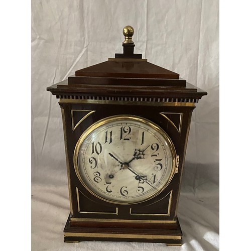 259 - A Regency style bracket clock with circular silvered dial, in a mahogany and brass inlaid case with ... 