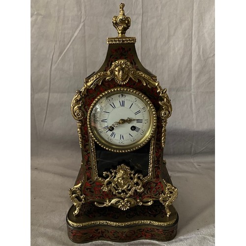 260 - A 19th Century French mantel clock with white enamel dial, in a red Buhl Rococo style case, complete... 