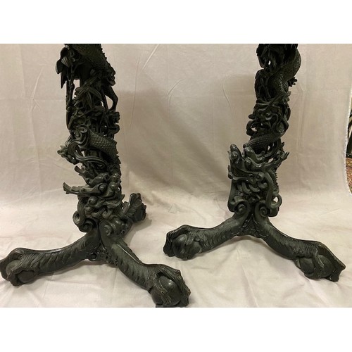 81 - A pair of 19th Century Chinese hardwood vase stands with inset marble tops, the columns carved in th... 