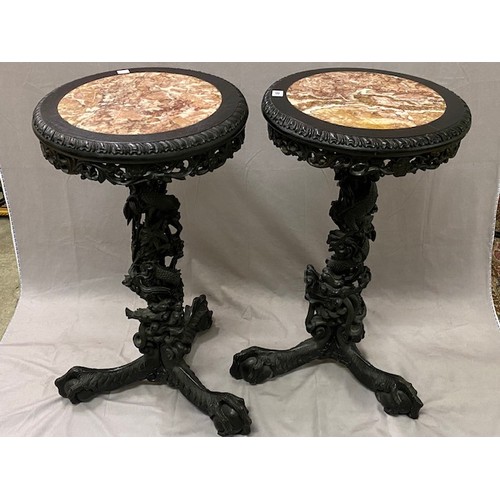 81 - A pair of 19th Century Chinese hardwood vase stands with inset marble tops, the columns carved in th... 