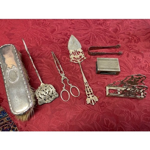 160 - A clothes brush with silver back, a Continental silver napkin ring, silver tongs etc..