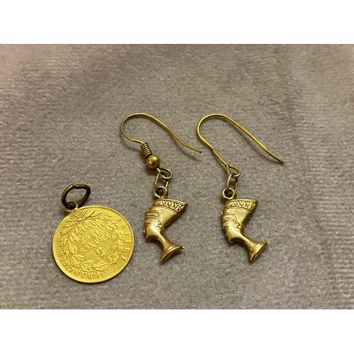 216 - A gold 5 franc coin as a pendant and a pair of gold coloured metal earrings in the form of busts of ... 