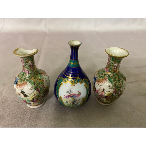 116 - A Continental small vase spill vase of bottle form, blue ground painted with a bird on flowering bra... 