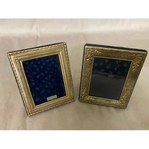 170 - A rectangular photograph frame with repousse decoration of ribbons and flowers - 5in. x 4in. and one... 