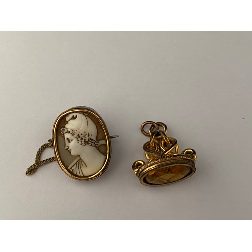 227 - A small carved shell cameo mounted as a brooch in a gold plated frame and a gold plated watch fob se... 