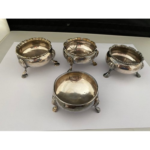 195 - Four Georgian silver circular open salts, each of three legs with pad feet, various dates and makers