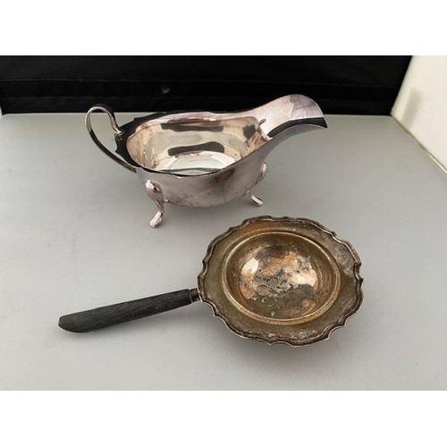 205 - A Viners silver sauce boat with serrated border, on three pad feet - Sheffield 1962 and a silver tea... 