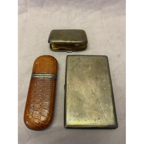 178 - An engine turned silver cigarette case, one other silver cigarette case and a crocodile skin effect ... 