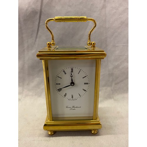 274 - A modern carriage clock retailed by Thomas Braithwaite of London with white enamel dial, in a brass ... 