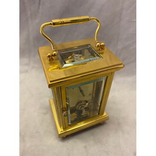 274 - A modern carriage clock retailed by Thomas Braithwaite of London with white enamel dial, in a brass ... 