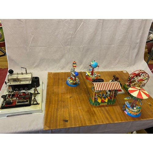 287 - A tin plate model of a fairground with three rides (some Wilesco), three other mechanical items and ... 