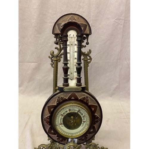 63 - A small Victorian aneroid barometer and thermometer on a carved walnut mount