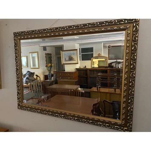 77 - A rectangular wall mirror in a gilded frame and one other - 39in. x 28in.