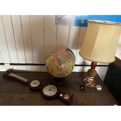 93 - A globe tablelamp, a turned wood tablelamp base and a battery operated barometer and thermometer on ... 