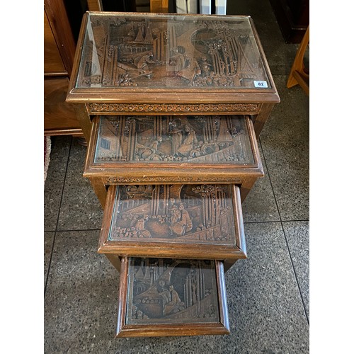 82 - A nest of four Chinese occasional tables with carved decoration - the largest 20in. wide