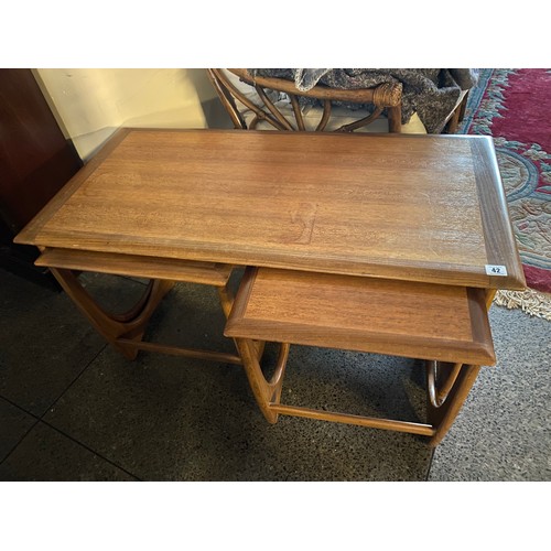 42 - A G Plan teak coffee table with rectangular top, fitted two nesting tables - 39in. wide