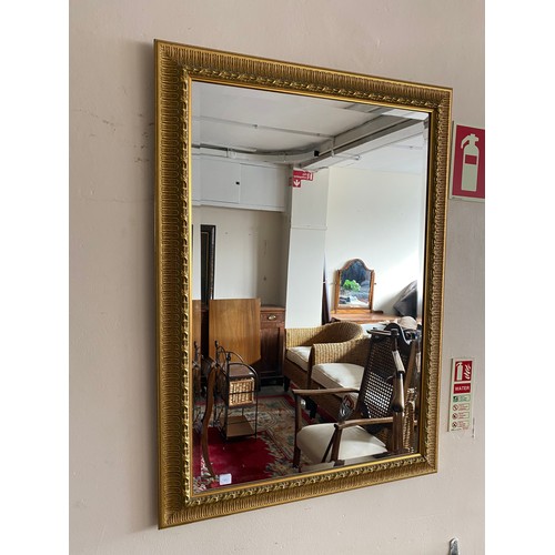 77 - A rectangular wall mirror in a gilded frame and one other - 39in. x 28in.