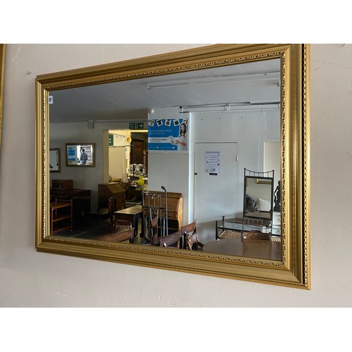 56 - A rectangular wall mirror in a gilt frame - 42in. x 30in.