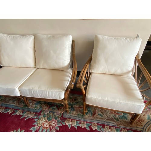 45 - A three piece cane conservatory suite comprising:- two seater settee and pair of matching armchairs,... 