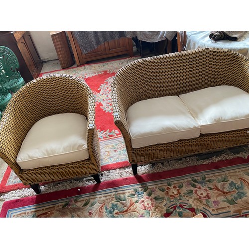 61 - A modern wicker three piece conservatory suite with loose seat and back cushions comprising:- two se... 