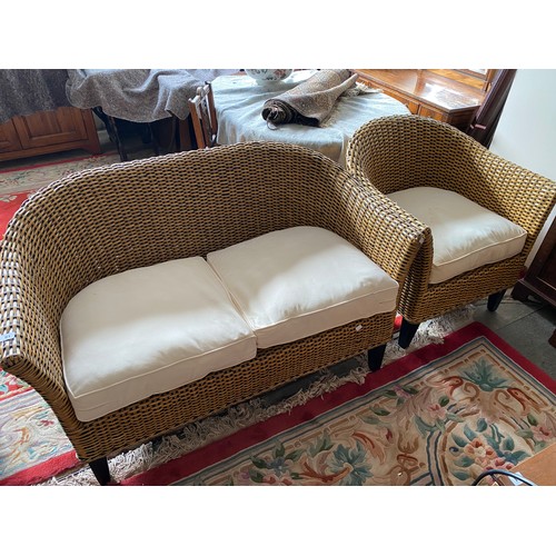 61 - A modern wicker three piece conservatory suite with loose seat and back cushions comprising:- two se... 