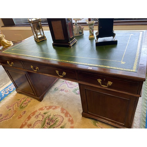 53 - A mahogany partners desk with green and gilt tooled leather top, fitted three frieze drawers to each... 