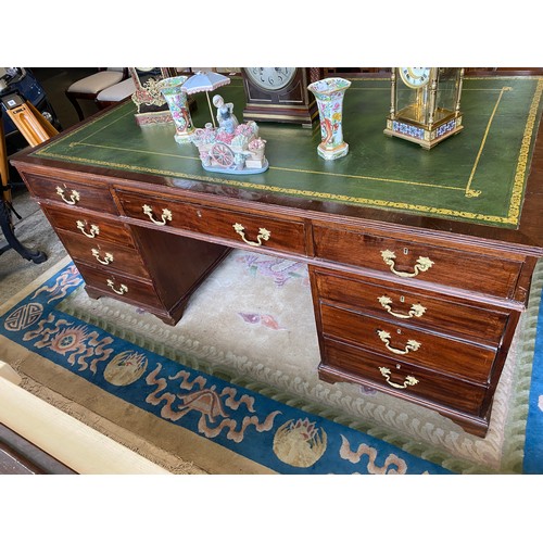 53 - A mahogany partners desk with green and gilt tooled leather top, fitted three frieze drawers to each... 