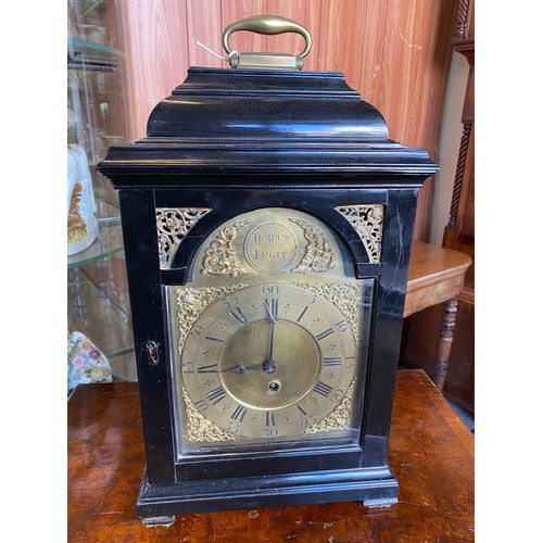 80 - A bracket clock with silvered dial, fusee movement, in an ebonised case with carrying handle - 21 1/... 