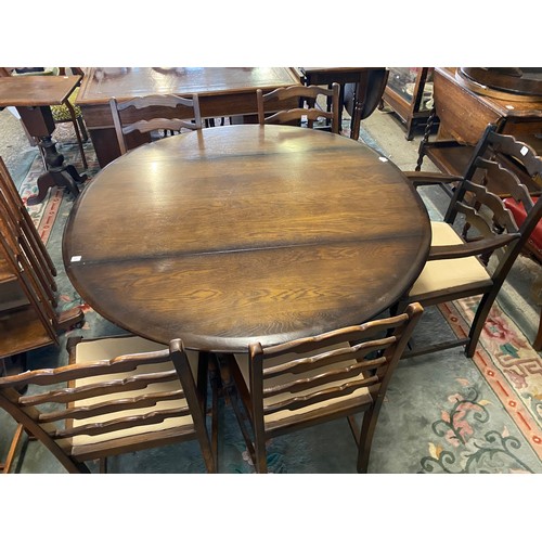 66 - An Ercol dark oak dining room suite comprising:- dining table fitted two rounded drop flaps, on pane... 