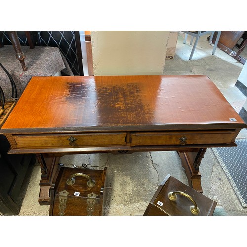 101 - A Victorian pitch pine writing table with rectangular top, two frieze drawers, on panelled ends with... 