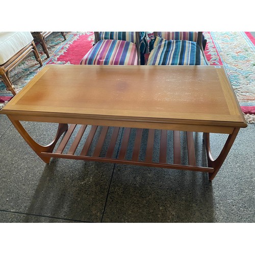 98 - A G Plan teak coffee table with magazine rack under - 43in. wide