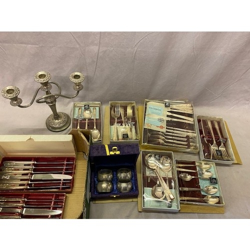 189 - A plated twin branch candelabra, a selection of Sheffield silver plated flatware boxed, a set of fou... 