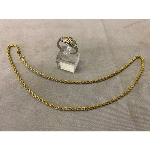 245 - A 9ct. gold ropetwist necklace and a 12kt. gold and sterling ring