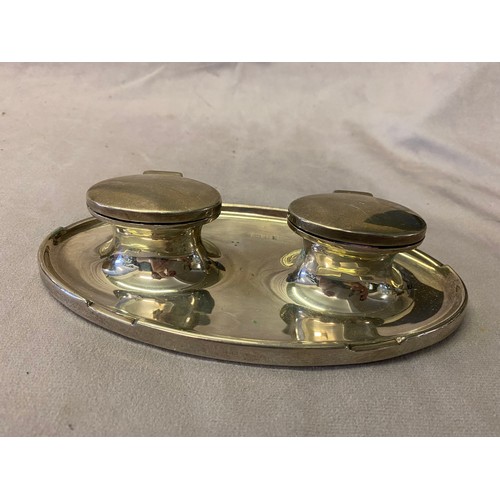 150 - An oval silver desk stand fitted two lidded inkwells