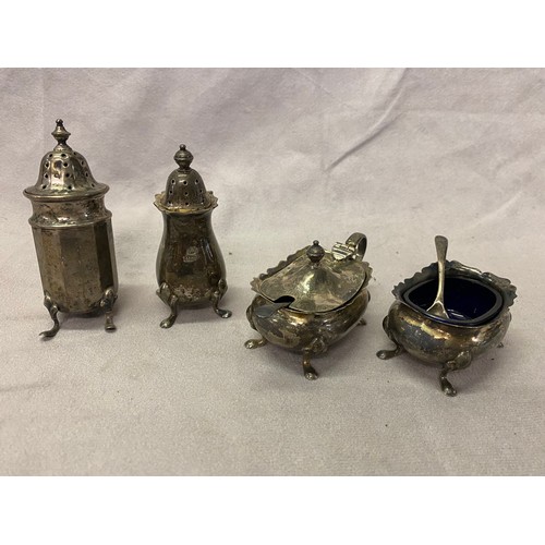 147 - A silver three piece cruet set and a silver pepperette of panelled form, on three legs, together wit... 