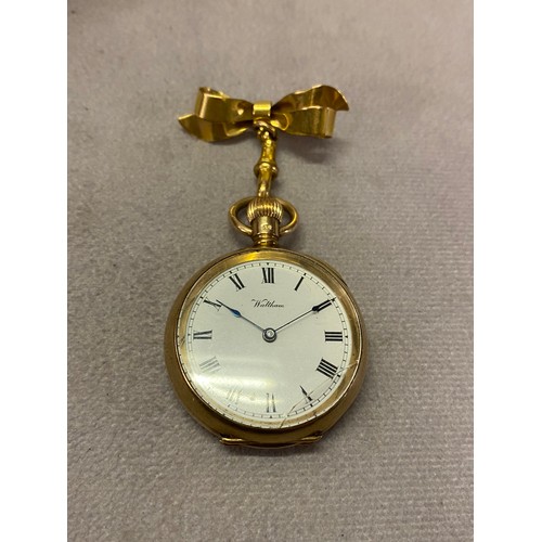 219 - A lady's Waltham open face pocket watch with white enamel dial, in a 9ct. gold case, on a 9ct. gold ... 