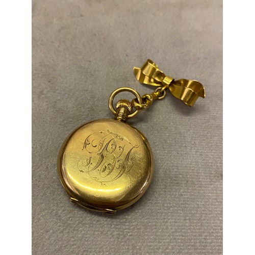 219 - A lady's Waltham open face pocket watch with white enamel dial, in a 9ct. gold case, on a 9ct. gold ... 