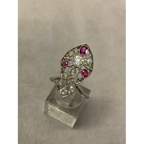 223 - A lady's ring set diamonds and rubies to flower design, mounted in white metal