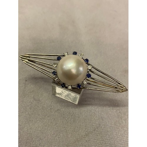 213 - A lozenge shaped brooch set mabe pearl surrounded by alternate diamonds and sapphires mounted in whi... 